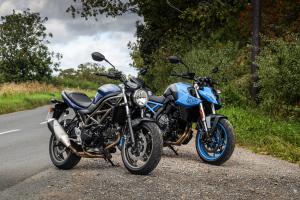 Two motorcycles parked at the side of the road